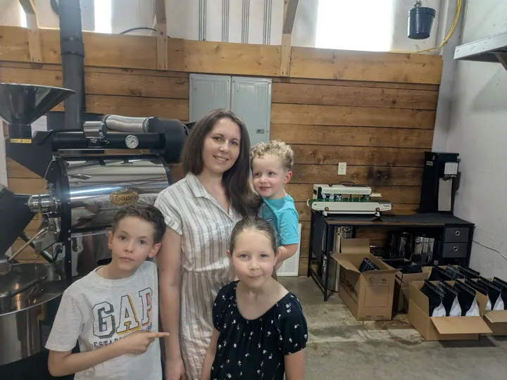 Family standing inside the Brotherhood Coffee roastery