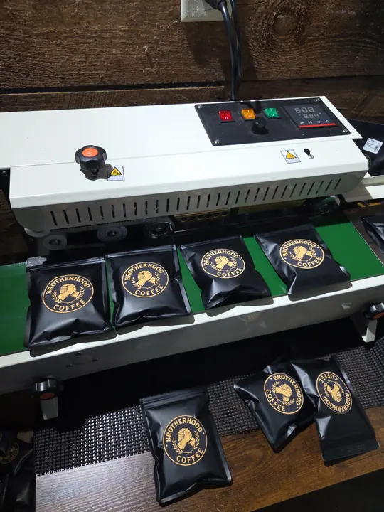 Brotherhood Coffee bags moving through a packaging line